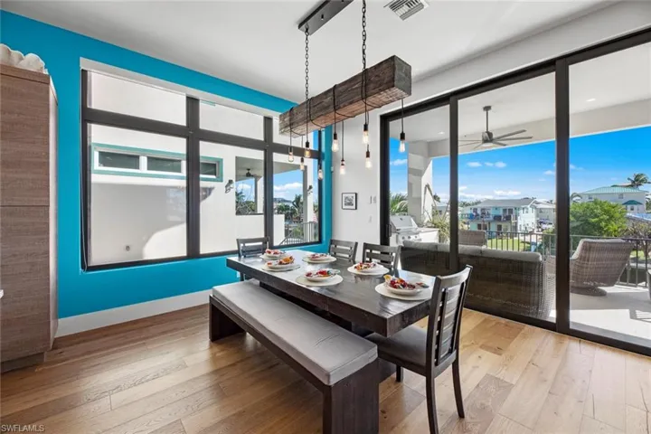 Dining space featuring ceiling fan and light wood flooring