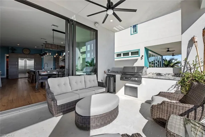 View of patio / terrace with grilling area, ceiling fan, area for grilling, sink, and an outdoor hangout area