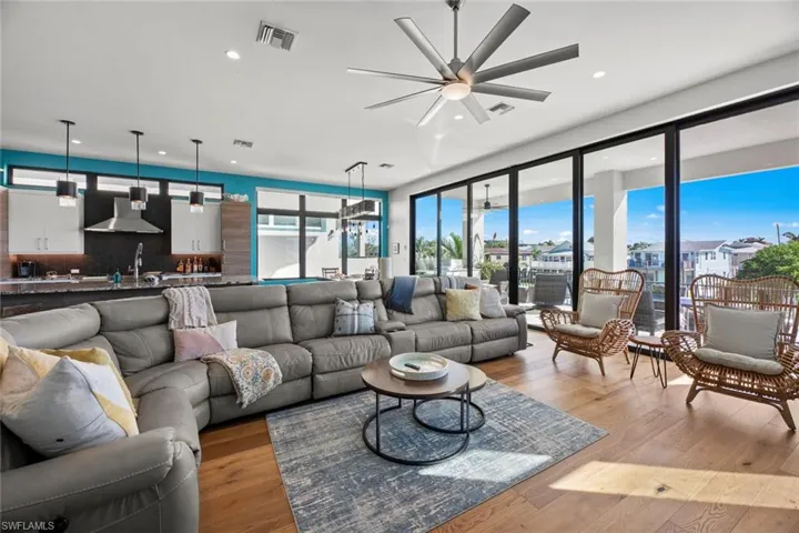 Living room with light wood-type flooring and ceiling fan