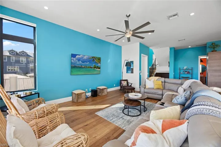 Living room featuring hardwood / wood-style floors and ceiling fan