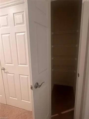 Clothes washing area featuring light tile patterned floors and washer and clothes dryer