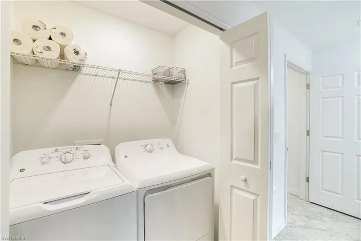 Laundry area with washing machine and clothes dryer
