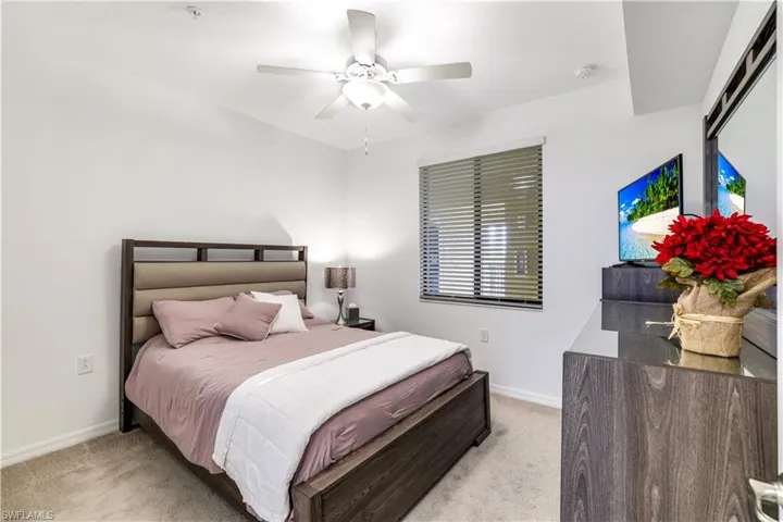 Bedroom featuring light colored carpet and ceiling fan