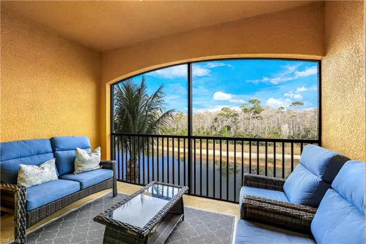 Sunroom / Lanai with a water view