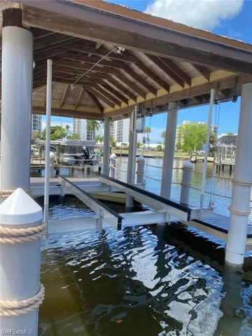 Dock featuring boat lift and a water view