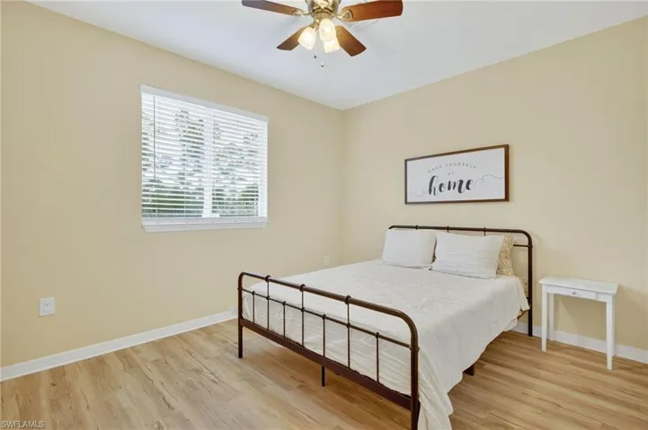 Bedroom with light wood-style floors and ceiling fan