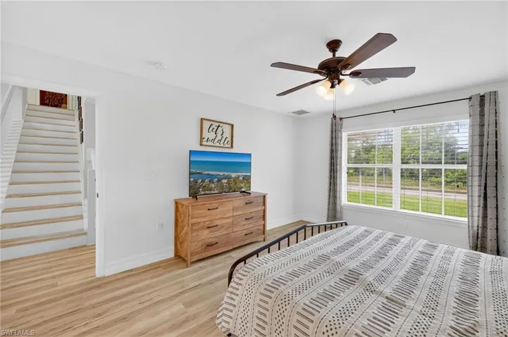 Bedroom with light wood-style floors and ceiling fan