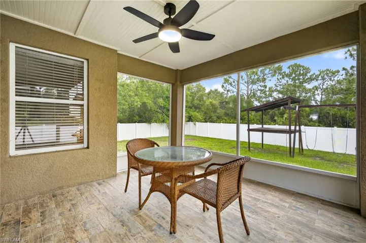 Sunroom featuring outdoor dining space and a ceiling fan