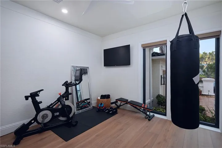 Spacious room featuring white oak flooring, recessed lighting, and large windows