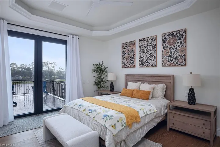 French doors opening to an outdoor balcony with metal railings and water views