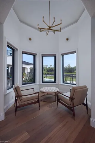 primary bedroom sitting area overlooking the pool