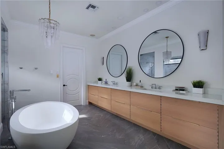 Freestanding soaking tub with floor-mounted faucet