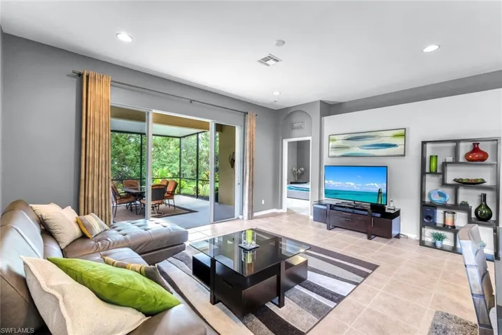 Living room with tile patterned floors and recessed lighting