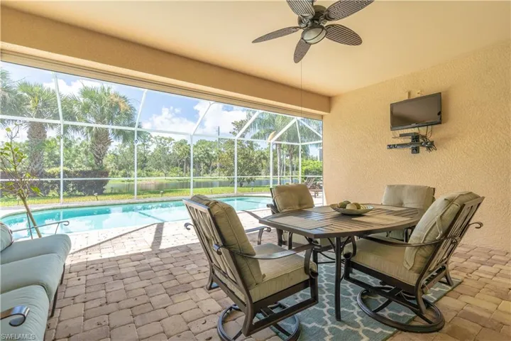 Sunroom featuring ceiling fan and plenty of natural light