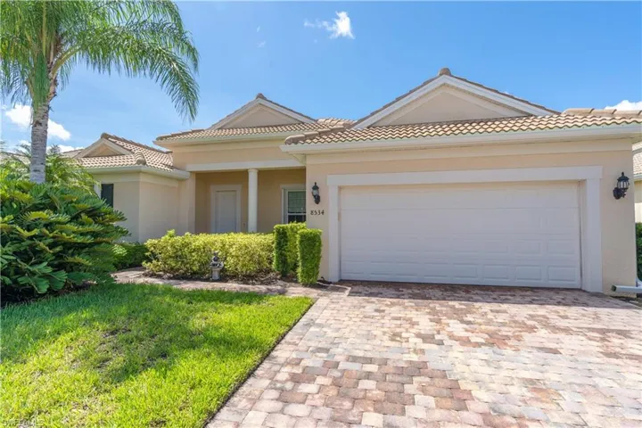 Mediterranean / spanish-style home with a garage