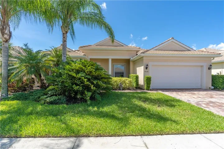 Mediterranean / spanish-style home featuring a garage and a front lawn