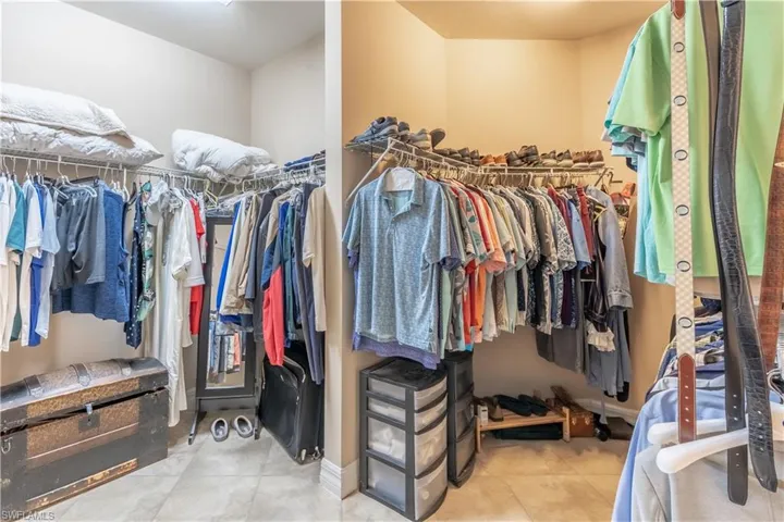 Spacious closet with light tile patterned floors