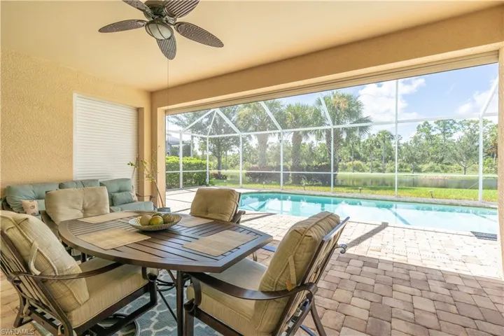 Sunroom with a wealth of natural light and ceiling fan