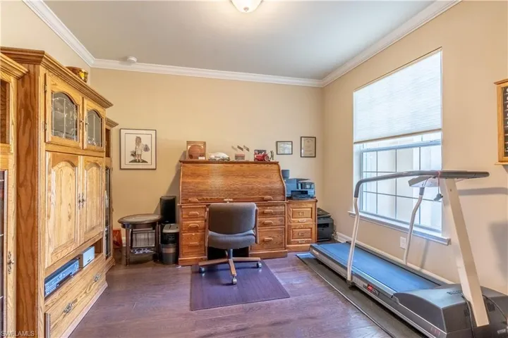 Office space featuring crown molding and dark hardwood / wood-style flooring
