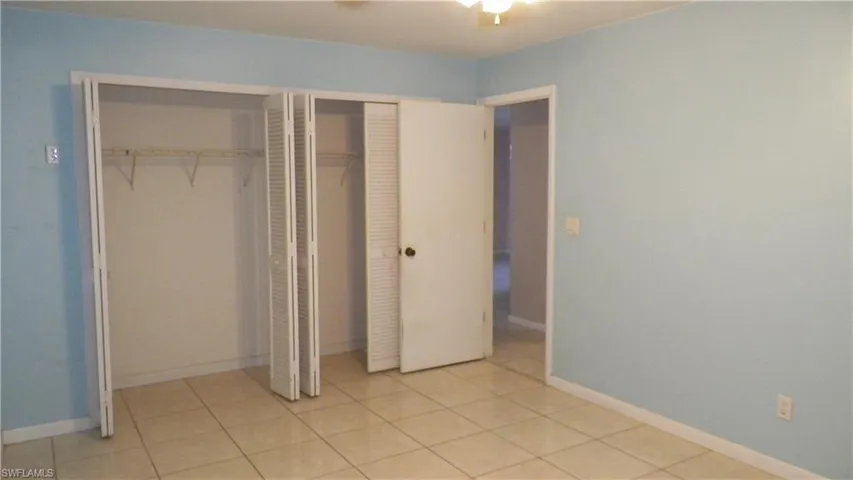 Interior room featuring ceramic tile flooring and light blue wall paint
