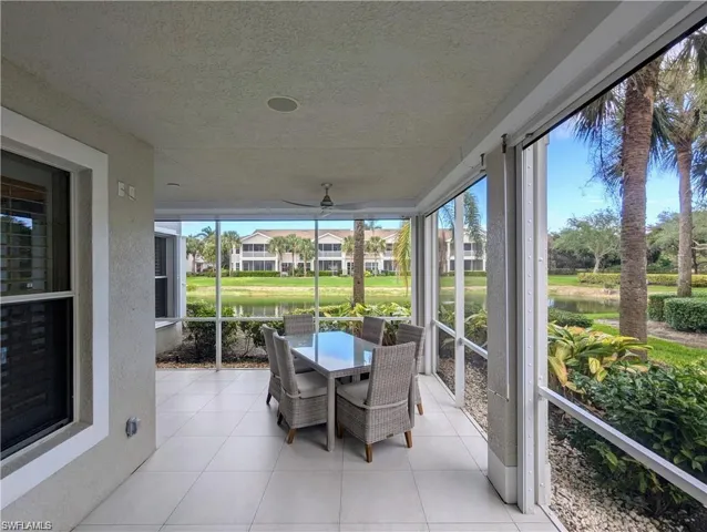Sunroom / solarium with a water view and outdoor dining space