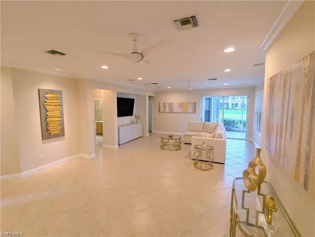 Living area with crown molding and recessed lighting