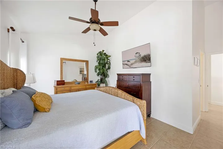 Bedroom featuring light tile patterned floors and a ceiling fan