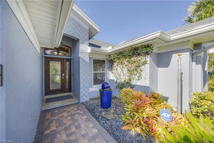 Entrance to property with stucco siding