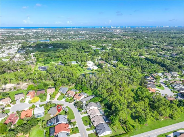 Aerial view of property and surrounding area featuring nearby suburban area