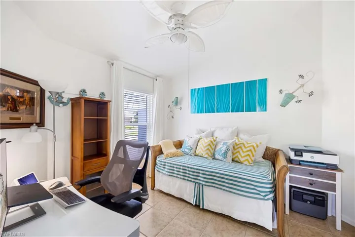 Tiled bedroom with ceiling fan