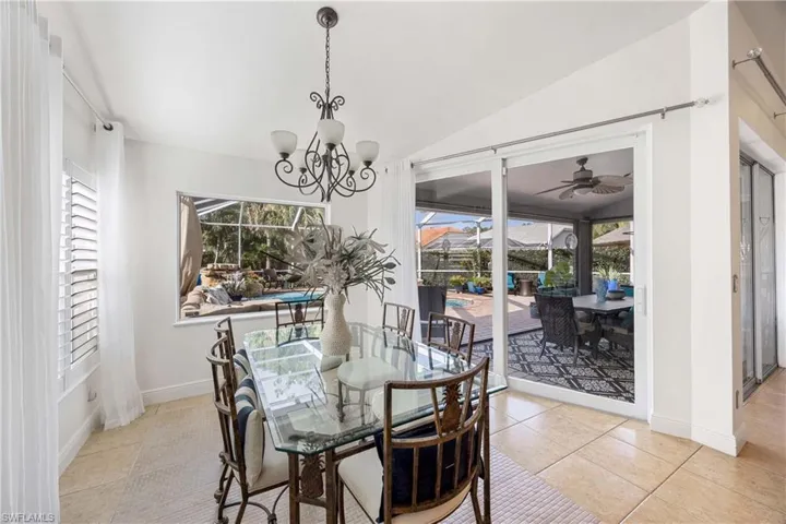 Dining room featuring a sunroom, lofted ceiling, plenty of natural light, ceiling fan, and tile patterned floors