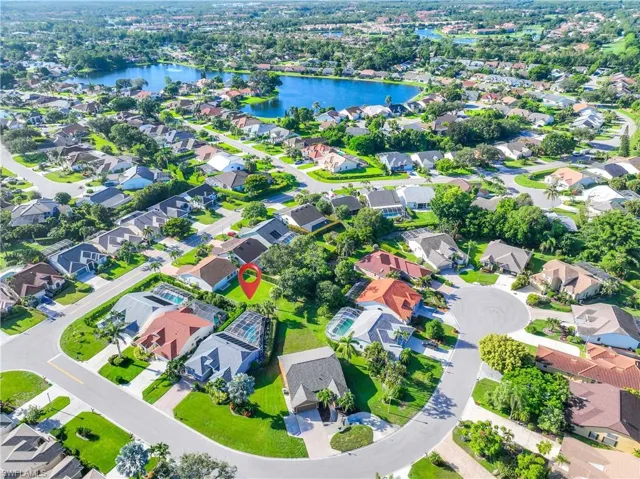 Aerial view of residential area featuring a nearby body of water