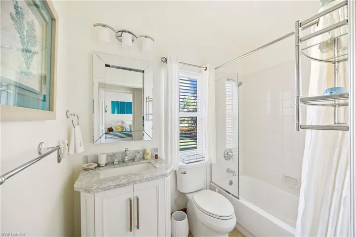 Full bathroom featuring shower / tub combo with curtain and vanity