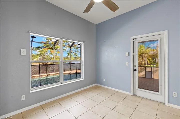 Featuring a ceiling fan and light tile patterned flooring