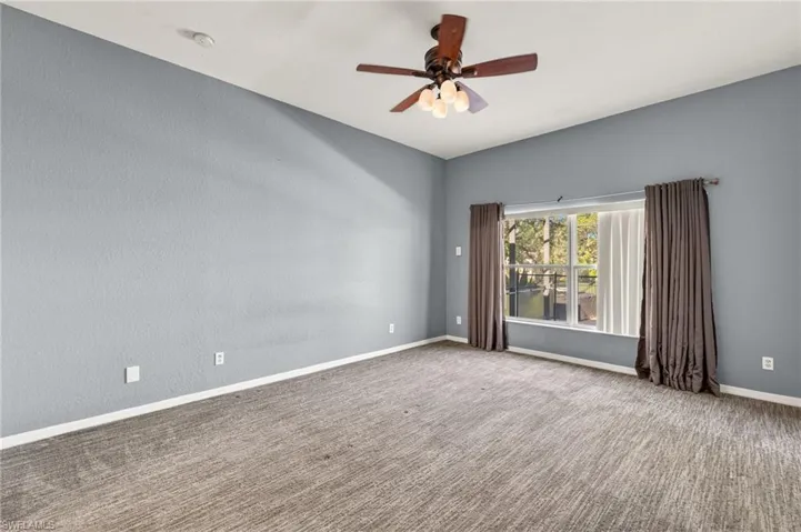 bedroom with a ceiling fan and a smoke detector