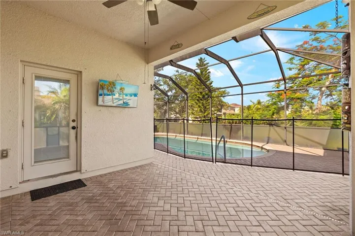 View of pool with a ceiling fan, a patio area, and a lanai