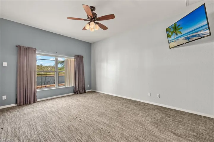 be room with ceiling fan and carpet floors