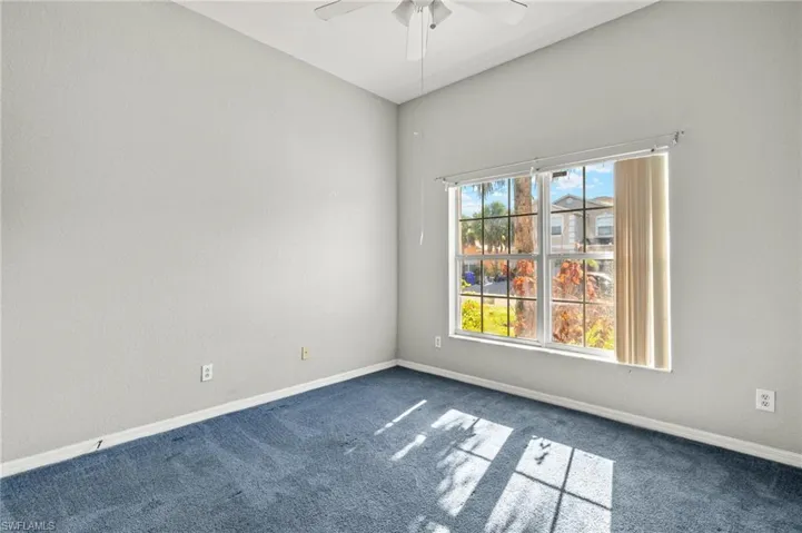 bedroom featuring dark colored carpet and a ceiling fan