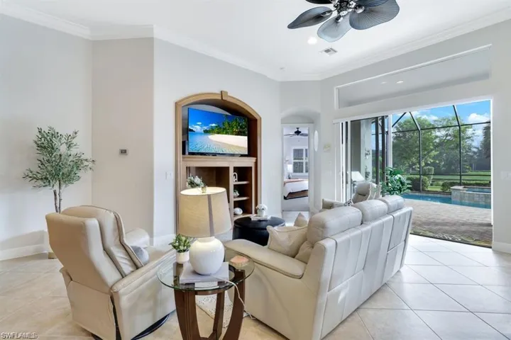 Living area featuring ornamental molding, light tile patterned floors, a sunroom, a ceiling fan, and recessed lighting