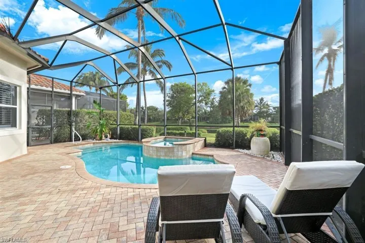 View of pool with a sunroom, a patio area, a lanai, and a pool with connected hot tub