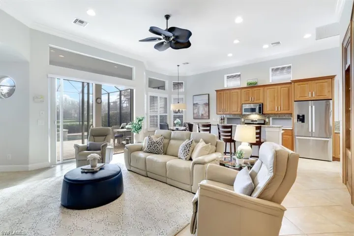 Living area featuring ornamental molding, ceiling fan, recessed lighting, and light tile patterned floors