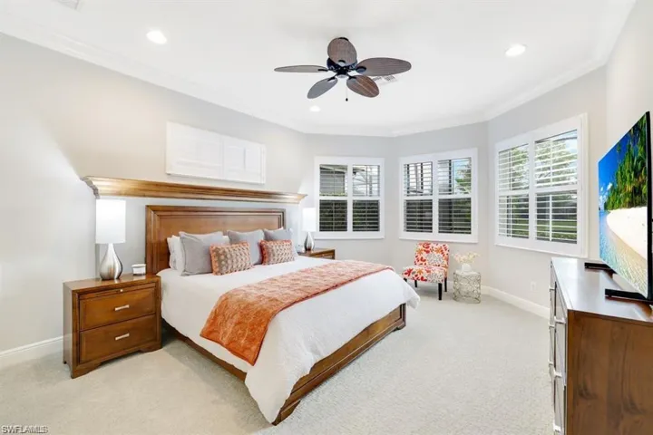 Bedroom featuring ornamental molding, light carpet, ceiling fan, and recessed lighting