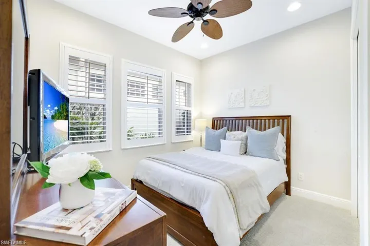 Carpeted bedroom featuring a ceiling fan and recessed lighting