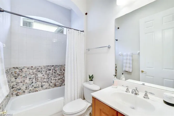 Bathroom with shower / bath combo and vanity