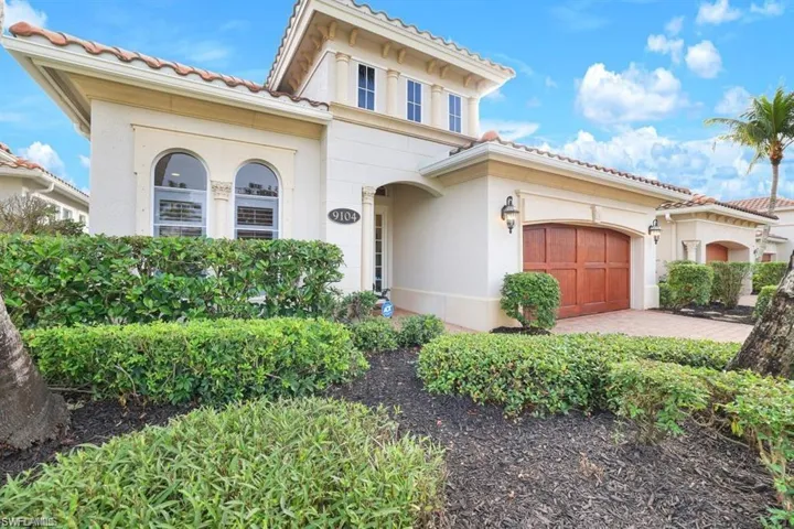 Mediterranean / spanish-style house featuring a tiled roof, stucco siding, and driveway
