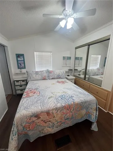 Primary Bedroom with Vaulted Ceiling, Bath, Laminate Flooring and Ceiling Fan