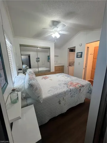 Primary Bedroom with Vaulted Ceiling, Bath, Laminate Flooring and Ceiling Fan