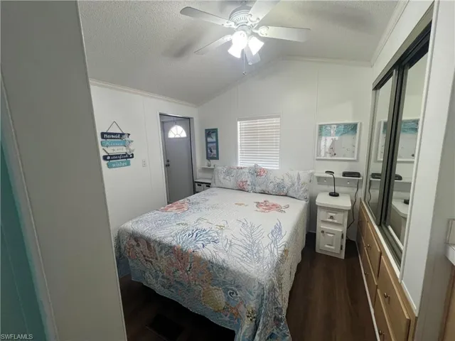 Primary Bedroom with Vaulted Ceiling, Bath, Laminate Flooring and Ceiling Fan