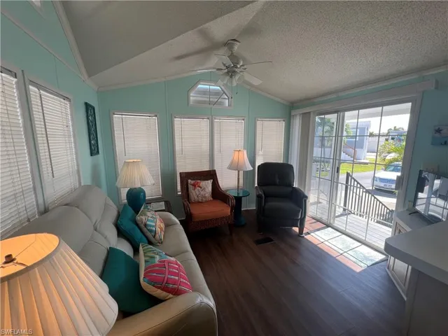 Living Room with Vaulted Ceiling, Laminate Flooring and Ceiling Fan