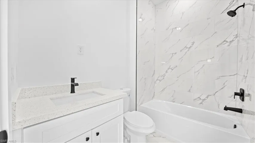 Full bath featuring vanity and  shower combination